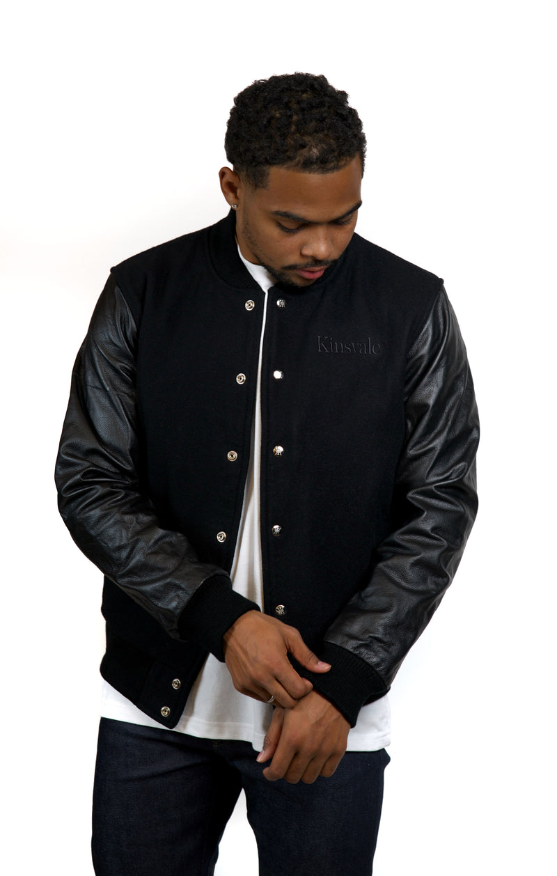 Black varsity on sale jacket leather sleeves